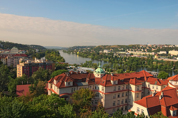 Fototapeta na wymiar A picturesque view of residential buildings near the Vltava river. Summer landscape photo on a sunny morning. Prague, Czech Republic