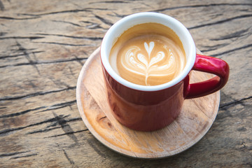 Top view of hot coffee latte on wood table background.