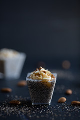 Chia pudding with mashed banana and sliced almonds, view from a side