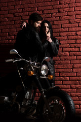Fototapeta na wymiar fashion couple. fashion couple at cool motorbike. sexy couple in fashion leather jacket. fashion couple concept. love their style.