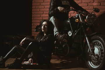 Fototapeta na wymiar hell riders. biker couple are hell riders. hell riders on motorcycle. man and woman hell riders in leather jacket