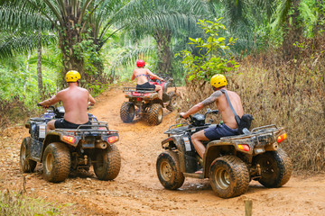 PHUKET, THAILAND - AUGUST 23 : Tourists riding ATV to nature adventure on dirt track on AUGUST 23, 2014, Thailand. © sorraphurk
