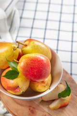 organic pears laying down on a lightly dotted kitchen cloth