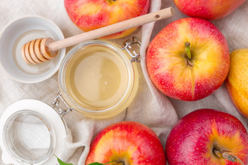 Jewish holiday Rosh Hashanah background with honey and apples on wooden table.