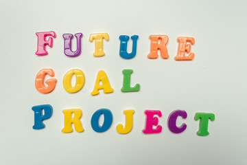 Future goal project words written in plastic colorful letters on white background