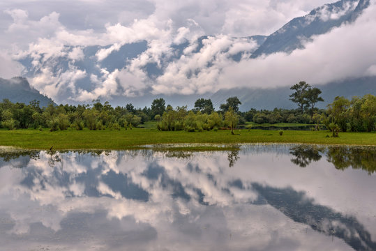 clouds mist lake reflections mountains