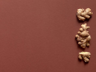 Minimalism inspirated set of ginger roots over a yellow background in studio.