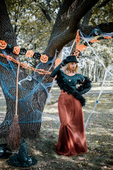 Elegant, charming, shy, playful, flirty, dangerous, mysterious, scary female beauty. Close up portrait of gorgeous happy witch fairy enchantress, covering her eyes, carnaval halloween concept 