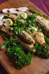 Fried fish on wooden board