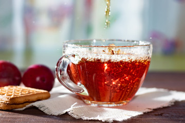 Hot drink. Pour the hot fruit tea into a glass cup.