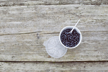 Blueberries in a plate on a wooden background