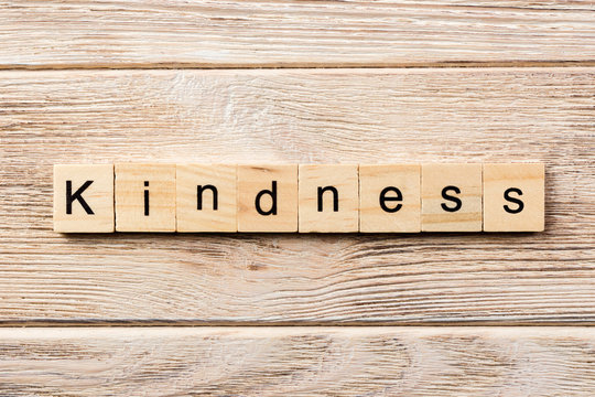 kindness word written on wood block. kindness text on table, concept