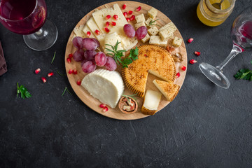 Cheese platter with fruits and wine