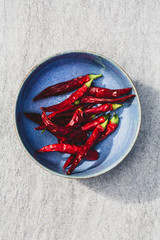 dried chili peppers in a blue bowl