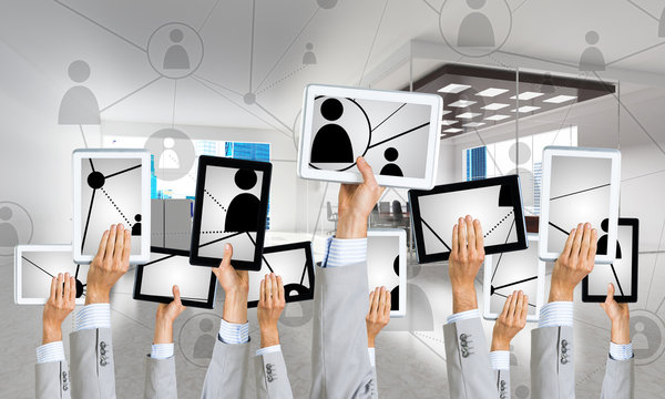 Close of businessman hands in line showing tablet pc presenting social connection concept. Mixed media