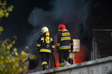 firefighters during the action of extinguishing a powerful fire of a recycling company.Poland,...