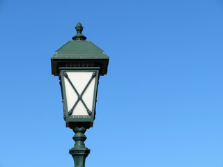 Fototapeta na wymiar Vintage street lamp isolated on clear blue sky. Street light, old fashioned green lantern