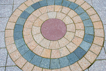 Pavement laid out with yellow and gray stones for decoration in the city