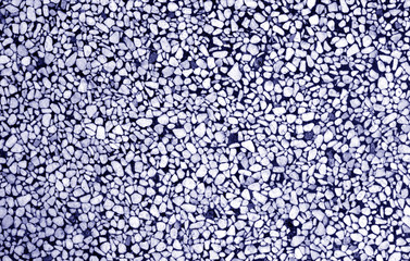 Wall made of small stones in blue tone.