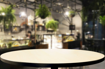 Selected focus empty brown wooden table and Coffee shop or restaurent blur background with bokeh image. for your photomontage or product display