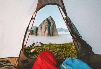 Camping tent mountain morning view travel couple in sleeping bags enjoying vacations adventure...