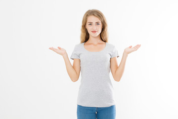 Portrait of smiling young blonde caucasian woman wearing summer t shirt pointing at copy space by hands isolated on white template and blank background. Advertising plase