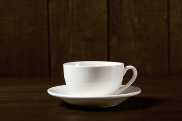 one classic coffee or tea cup on a dark wooden background