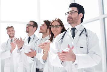 Fototapeta na wymiar group of doctors applauds, standing in the hospital