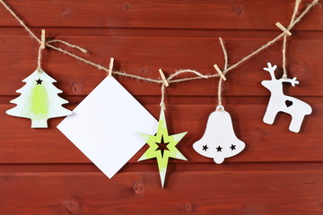 Composition of Christmas and New Year decorations made of plywood on a red wooden background.