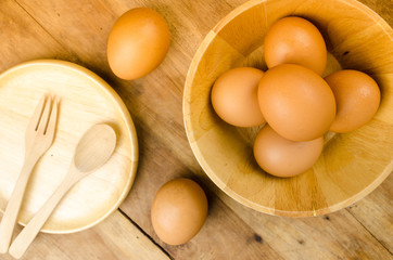 Brown eggs in wooden square bowl