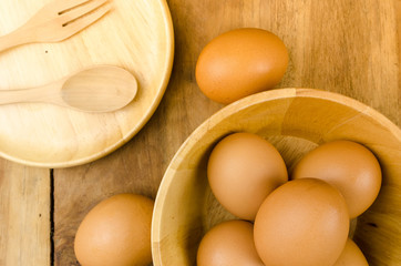 Brown eggs in wooden square bowl