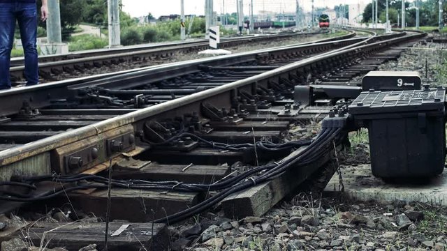 man fools with railroad switch and risks his life on the railway, life threatening