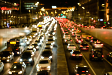 Fototapeta na wymiar Defocused lights car traffic jam of a street road at night retro color effect for background