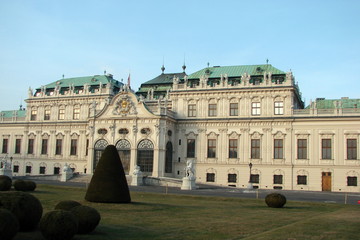 Obraz premium Panorama of imperial palaces and residences surrounded by neatly trimmed trees on the background of the blue winter sky.