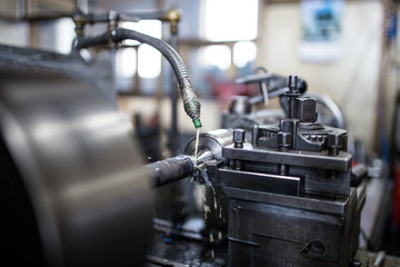 Metallurgy heavy industry. Factory for production industrial machines. Low light close up shot. Short depth of field.