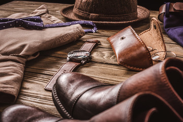 close up view of arrangement of masculine stylish shirt  and accessroies on wooden tabletop