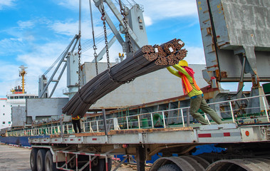 bundle of steel rod being loading discharging in port terminal, handle by gang of stevedore,...