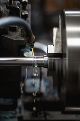 Metallurgy heavy industry. Factory for production industrial machines. Low light close up shot. Short depth of field.