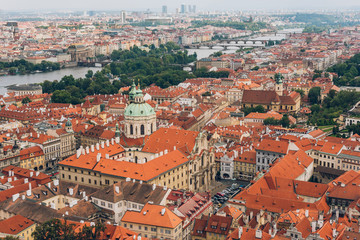 Fototapeta na wymiar aerial view of beautiful prague cityscape with rooftops, Charles Bridge and Vltava river