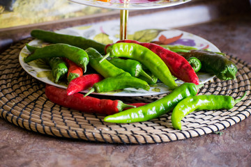 Chili. Green and red hot pepper on a wooden table. Red and green hot chili peppers. Variety of fresh organic peppers.