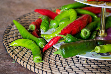 Chili. Green and red hot pepper on a wooden table. Red and green hot chili peppers. Variety of fresh organic peppers.