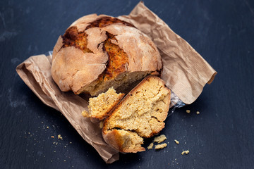 corn bread with knife on black ceramic background