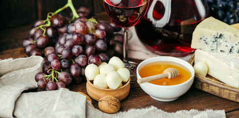Cheese and wine, Decanter and glasses, wooden background, appetizer, grapes, long banner