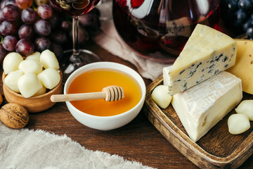 Cheese and wine, Decanter and glasses, wooden background, appetizer, grapes