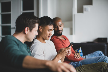Male friends looking at smartphone together