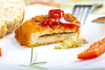 Chicken cordon Bleu on plate with tomato sauce or ketchup