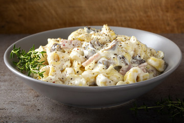 Ravioli with mushrooms and ham in a cream and cheese sauce