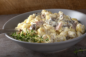 Ravioli with mushrooms and ham in a cream and cheese sauce