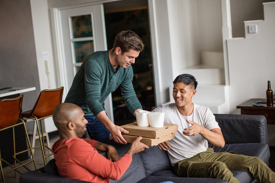 Male friends having takeout food delivered