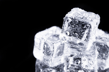 Three ice cubes on black background.